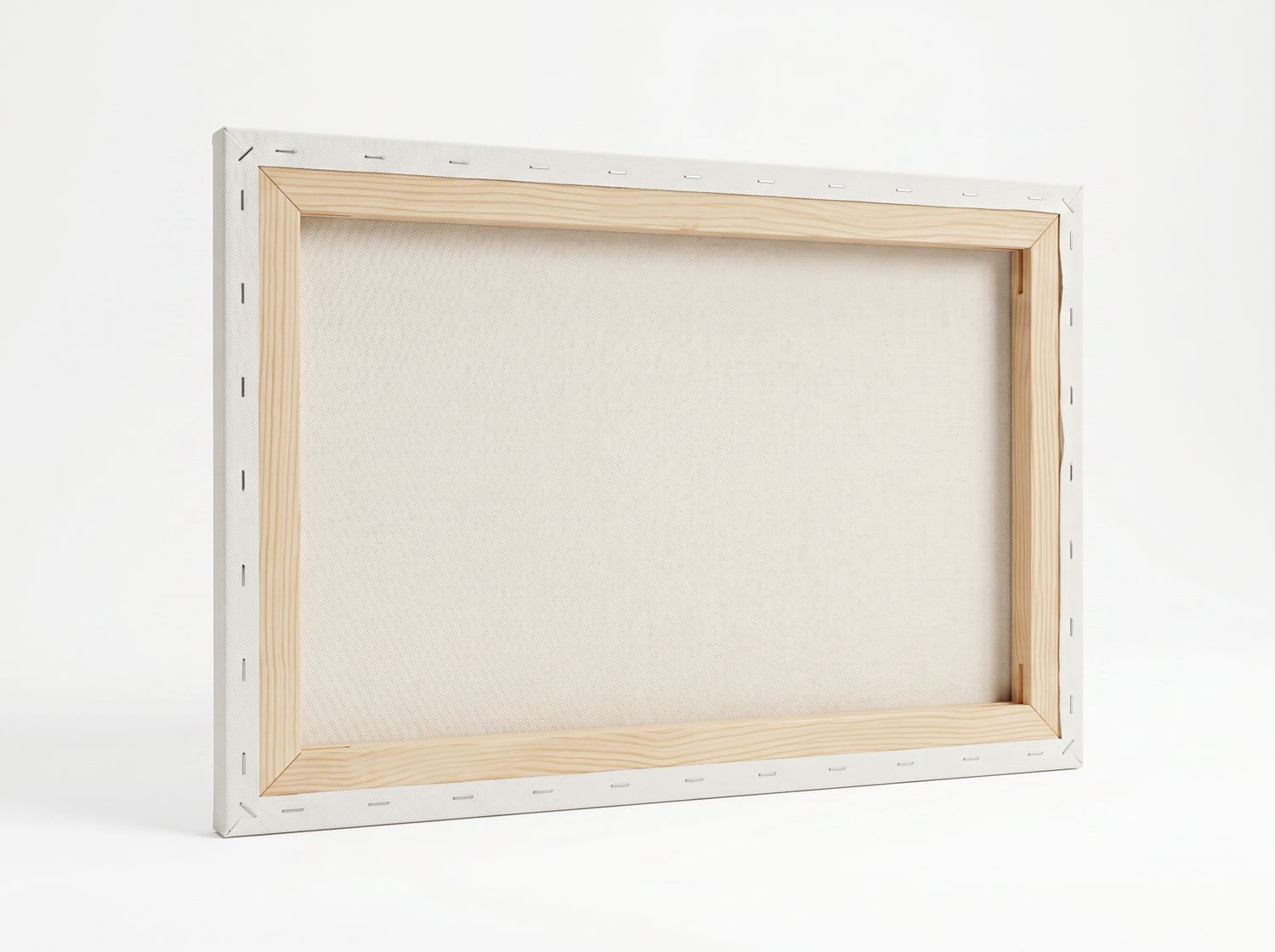 The back of the same canvas: mitred pine bars, even staple pitch, and the canvas weave visible through the frame void.
